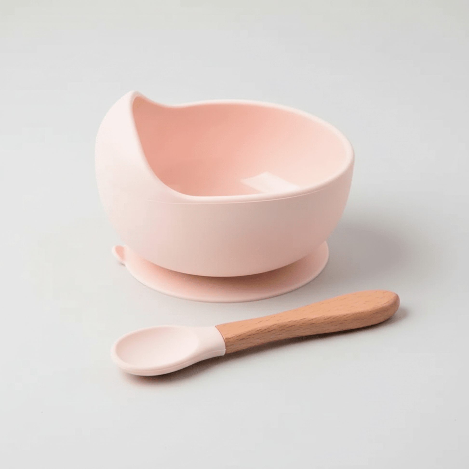assiette bebe silicone avec ventouse et sa cuillere assortie manche en bois tête en silicone coloris rose
