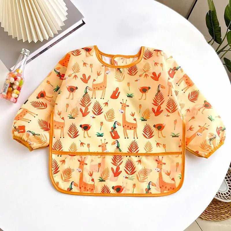 bavoir bébé étanche orange avec motifs girafes et oiseaux